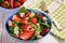 Spinach salad with strawberries, blue cheese, avocado and lemon.