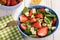 Spinach salad with strawberries, blue cheese, avocado and lemon.