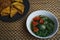 Spinach soup accompanied by tempeh and tofu