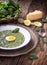 Spinach soup. Portion spinach soup with egg and cheese parmesan in retro style