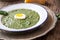 Spinach soup. Portion spinach soup with egg and cheese parmesan in retro style