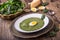 Spinach soup. Portion spinach soup with egg and cheese parmesan in retro style