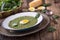 Spinach soup. Portion spinach soup with egg and cheese parmesan in retro style