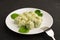 Spinacj and cheese gnocchi on white plate with fork