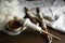 Spindles and soft white wool on wooden table