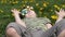 Spinner on the glasses is spinning. Fun on the street. Boy on a background of yellow flowers, dandelions.