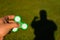 Spinner in male hands on a background of green grass and shadow man