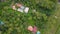 spinning aerial shot of secluded houses in dense jungle