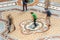 Spinning on the bull`s testicles of Galleria Vittorio Emanuele II in Milan, Italy