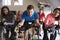 Spinning class on exercise bikes at a gym looking to camera