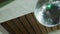 Spinning disco ball under a wooden ceiling