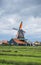 Spinning Dutch windmills from across farmland in Zaanse Schans  Netherlands