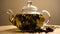 Spinning glass teapot with green tea