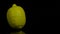 Spinning lemon in slow motion on a black background