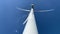 Spinning wind turbine against a blue sky