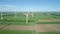 Spinning wind turbines - agricultural area, aerial view