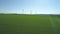 Spinning wind turbines - agricultural area, aerial view