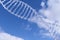 Spiral dna against the blue sky with clouds