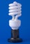 Spiral energy saving bulb on the background