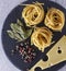 Spiral italian Macaroni Pasta isolated on shale board