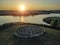 Spiral labyrinth made of stones, on sunset lake