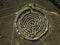 Spiral labyrinth made of stones, top view from drone