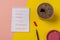 Spiral notebook with a hobbies list handwritten. Pink and yellow
