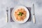 Spiral pasta mixed with cherry tomatoes and tomato sauce on a plate