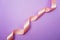 Spiral Pink ribbon on purple background