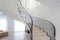 Spiral staircase in bright interior with white brick wall in elite expensive apartment