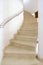 Spiral staircase in large spanish villa leading up to bedroom.