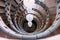 Spiral staircase made of marble with a spherical white lamps