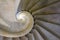 A spiral stone stair case shot from lower perspective