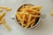 Spiral tortiglioni pasta in marble plate with two handles on light background. homemade pasta made from durum wheat. raw dish.