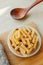 Spiral tortiglioni pasta in plate in bright kitchen. homemade pasta made from durum wheat. cooking Mediterranean dishes. food