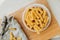 Spiral tortiglioni pasta in plate in bright kitchen. homemade pasta made from durum wheat. the process of cooking flour dishes.