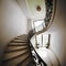 Spiraling Elegance: A Stunning Staircase in White Marble and Wrought Iron