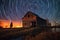 spiraling star trails above a peaceful rural barn