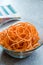 Spiralized Raw Sweet Potato in Glass Bowl Ready to Cook / Use