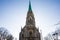 Spire with clock and stained glass-window of the Catholic Church of the Heart of Jesus Assumptions front view. Architecture of old