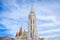 The spire of the famous Matthias Church in Budapest, Hungary. Roman Catholic church built in the Gothic style. Orange colored tile