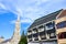 Spire of the Matthias Church in Budapest, Hungary on a horizontal photo with adjacent Socialist building. Roman Catholic church