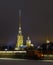 Spire of the Peter and Paul fortress on the background of sunset glow, night, beautiful lighting, horizontal shot. Symbol of Saint