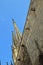 Spires and gargoyles on stone wall of church in Barcelona