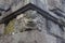 Spirit face made of stone as a block in a wall of a Hindu temple