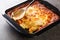 Spiritual Cod is a Portuguese casserole made of salt cod, carrot, bread, Bechamel sauce and topped with cheese closeup. Horizontal