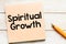 SPIRITUAL GROWTH words on a small piece of paper