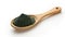 Spirulina or chlorella green powder in wooden spoon on white background. Dried seaweed. Superfood. Matcha Powder. Close