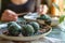 spirulina energy balls on a plate with a person in the background