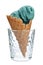 Spirulina ice cream cone in glass on white